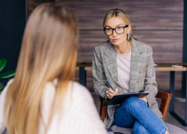 Two people are talking in an office
