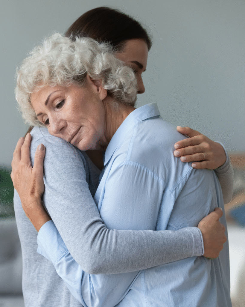 A person hugging another person in a living room